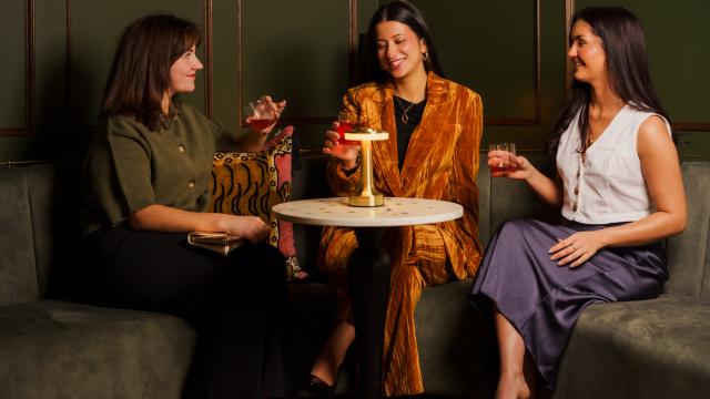 Three women sitting drinking rum